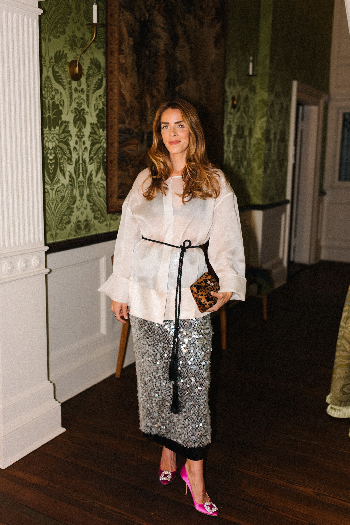 white sheer blouse sparkly silver skirt leopard bag black tassel belt