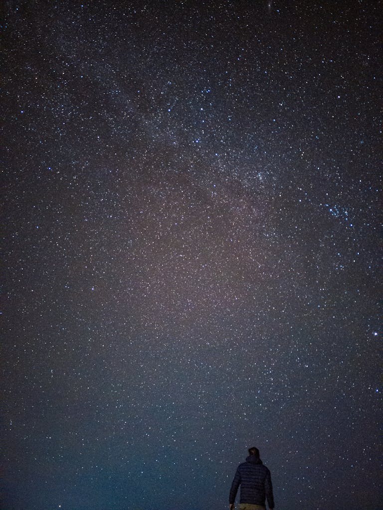 man standing in front of milky way
