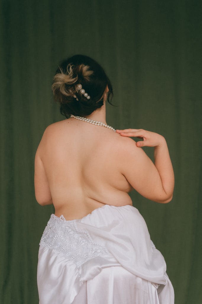 Elegant fashion portrait of a woman with pearls on a dark green background.
Why Plus Size High Waist Styles Are Called “Flattering” and Why That Rule Needs to Retire