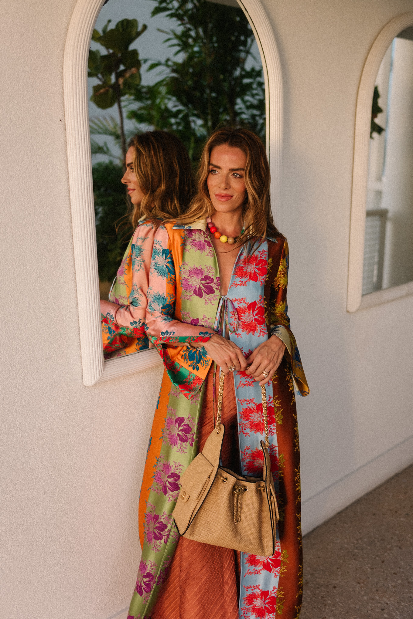 rainbow floral silk jacket silk wide leg pants rainbow beaded necklace rattan bag