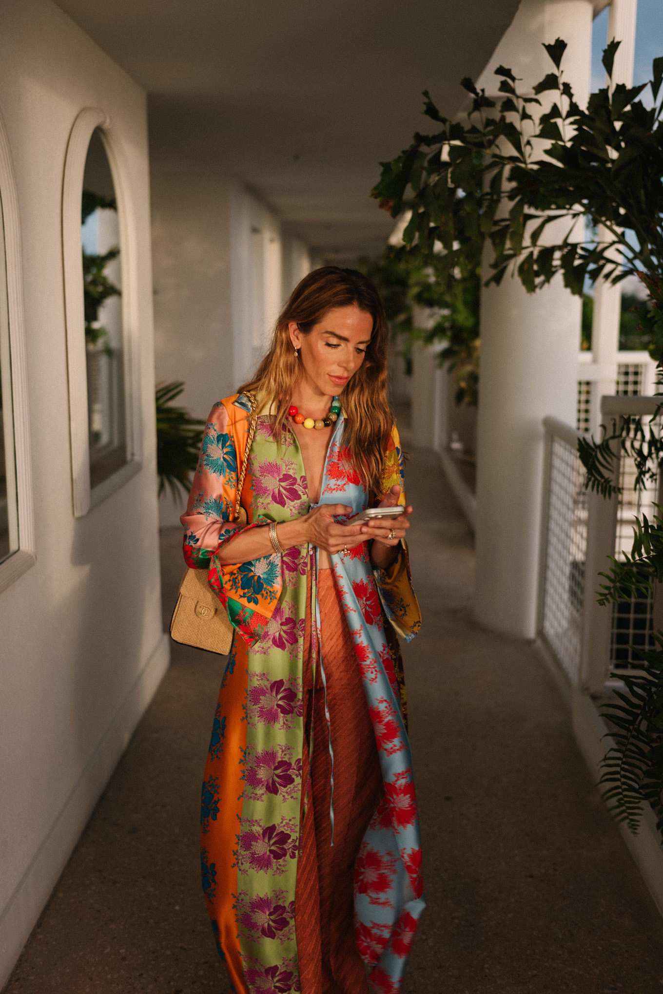 rainbow floral silk jacket silk wide leg pants rainbow beaded necklace rattan bag