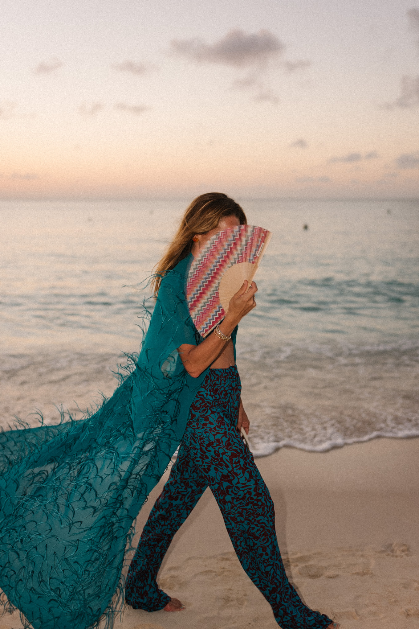 turquoise feathered maxi top turquoise printed wide leg pants wicker handbag
