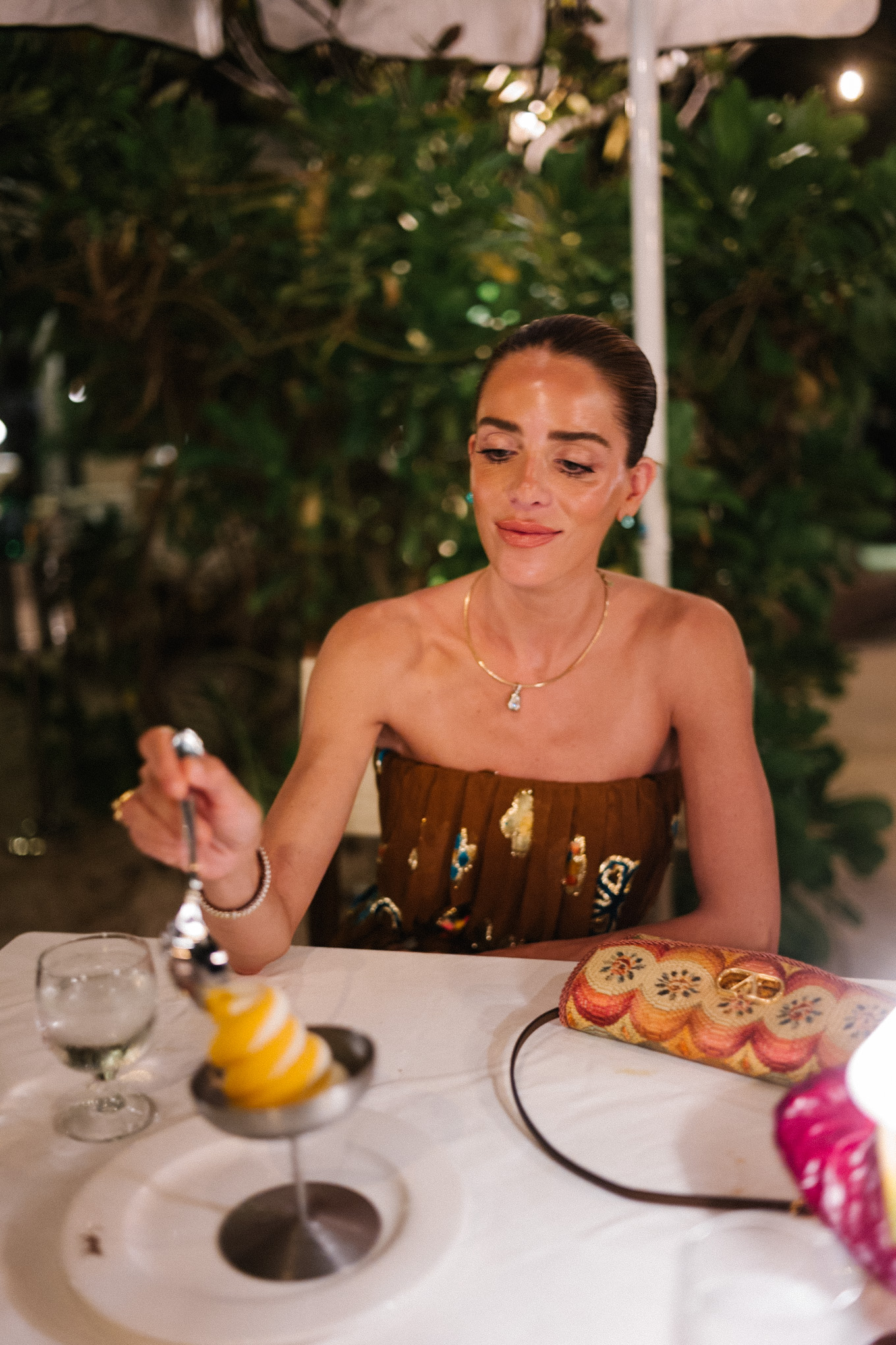 brown strapless maxi dress woven rainbow handbag