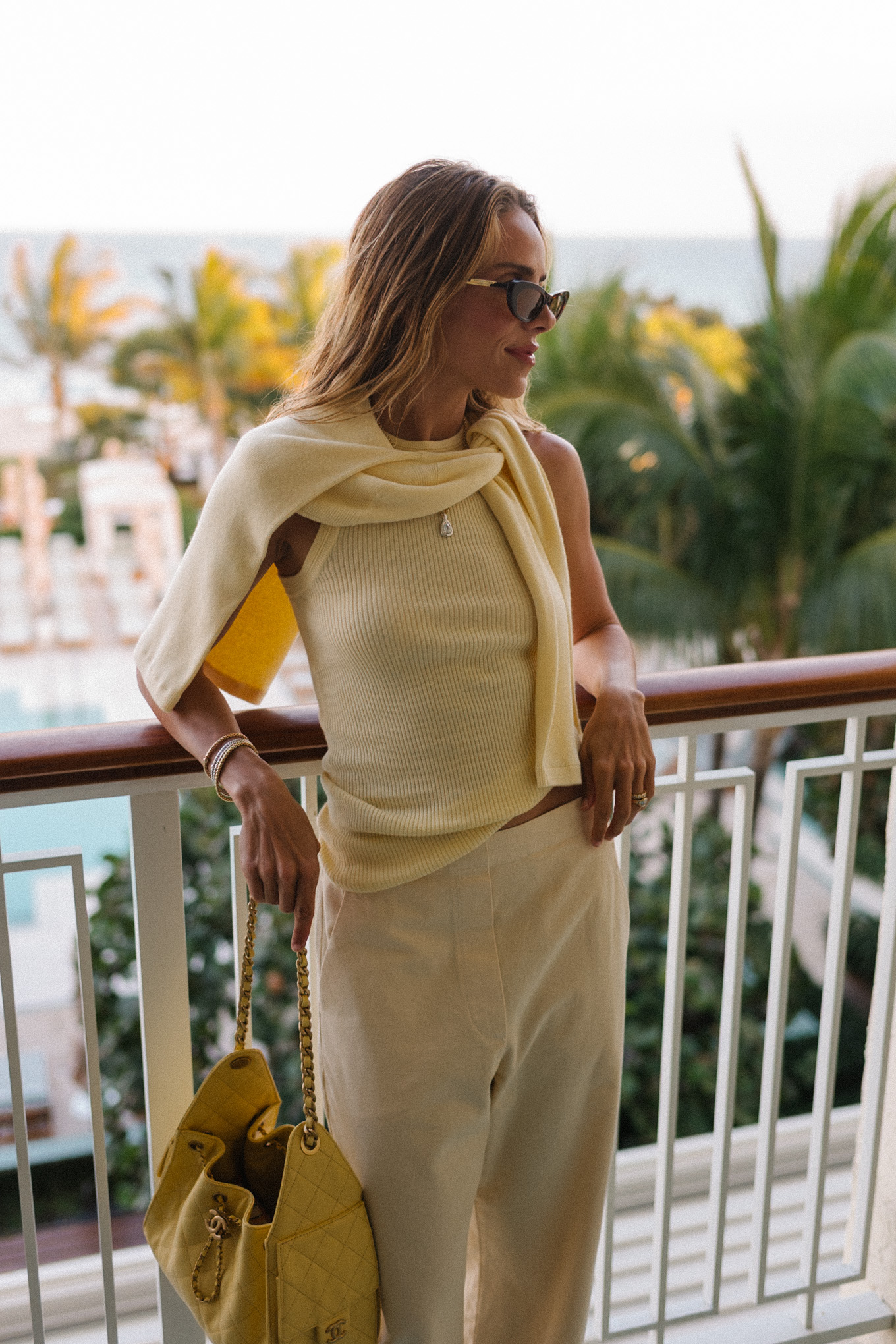 butter yellow sweater tank pants and handbag