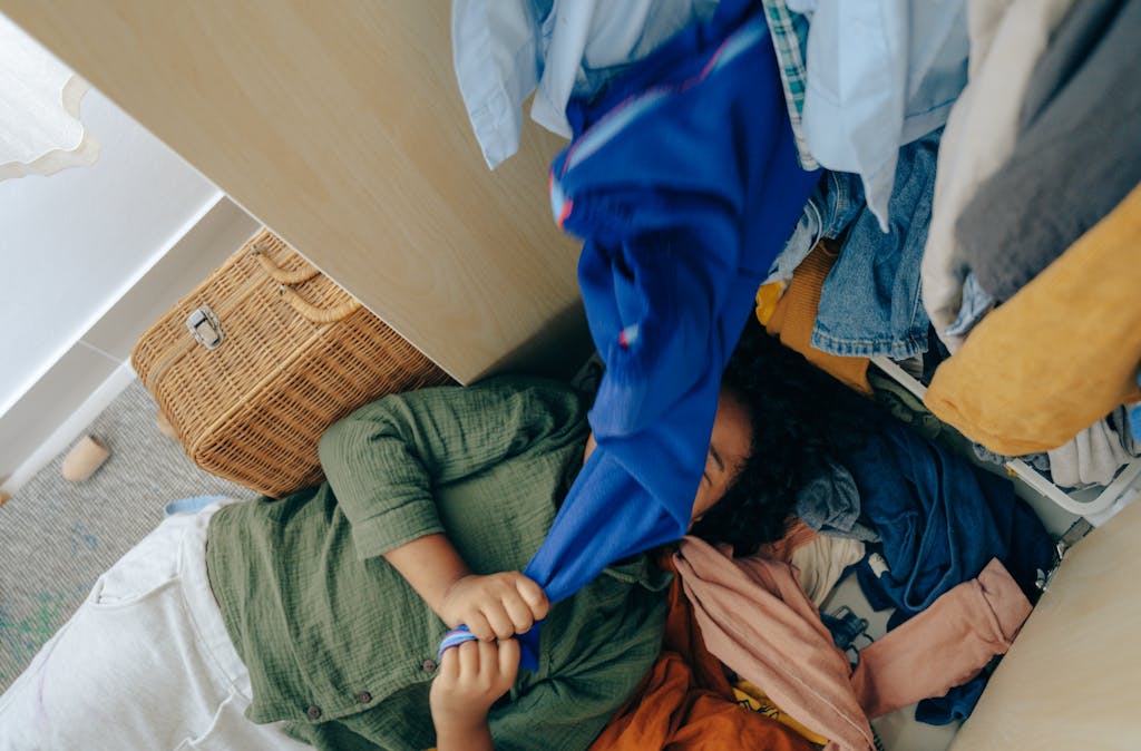 From above of faceless ethnic teenager having fun while arranging various clothes in wardrobe at home

clean up your wardrobe