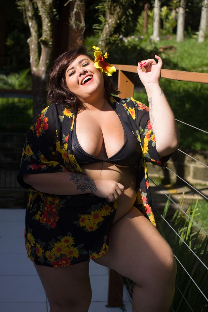 Confident plus size woman laughing in floral swimwear amidst nature in SP, Brazil.

summer spf tips