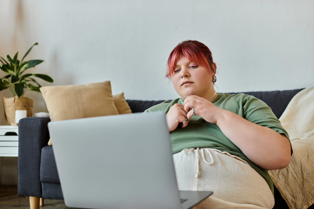 Plus size woman looking at laptop